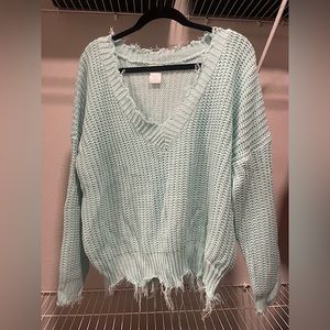 light-blue distressed v-neck sweater